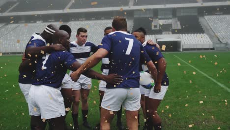 Animation-of-confetti-falling-over-happy-diverse-male-rugby-players-at-stadium