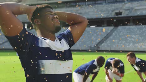 Animation-of-confetti-falling-over-african-american-male-rugby-player