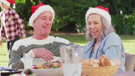 Happy-caucasian-family-having-christmas-dinner-in-garden