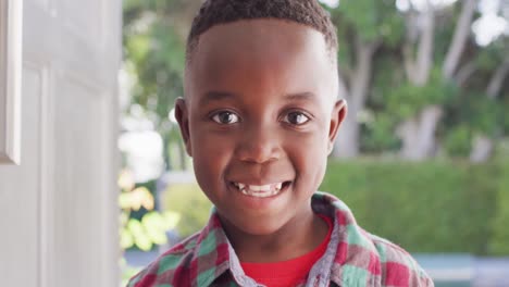 Portrait-of-happy-african-american-boy-at-door