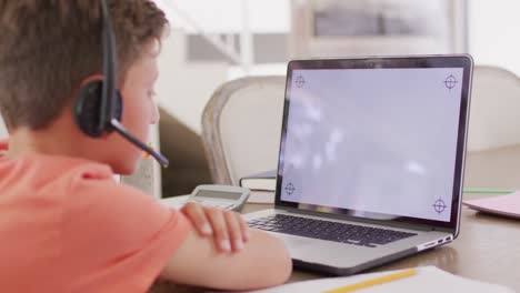Happy-caucasian-boy-having-video-call-on-laptop