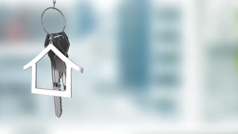 Animation-of-silver-house-key-fob-and-key-dangling-over-out-of-focus-interiors-with-copy-space