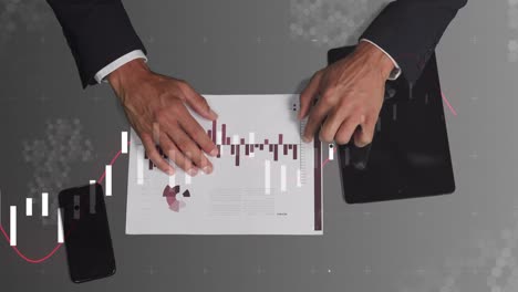 Animation-of-diverse-financial-data-and-graphs-over-hands-of-caucasian-businessman