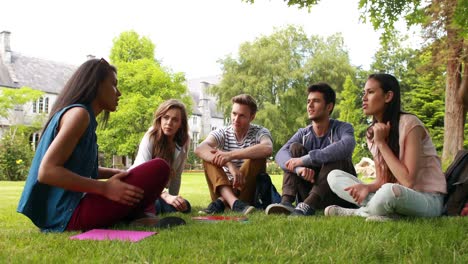 Friends-sitting-on-the-grass-and-speaking-