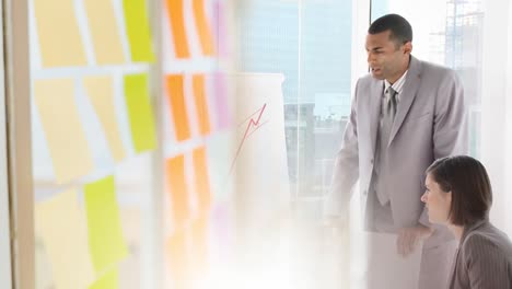 Animation-of-colorful-sticky-notes-over-two-caucasian-business-people