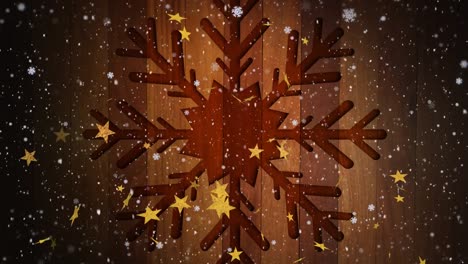 Animation-of-snow-falling-over-stars-and-christmas-decorations-on-wooden-background