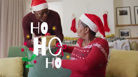 Animation-Des-Weihnachts-Ho-Ho-Ho-Textes-über-Einem-älteren-Afroamerikanischen-Paar-Mit-Weihnachtsmützen-Zu-Weihnachten
