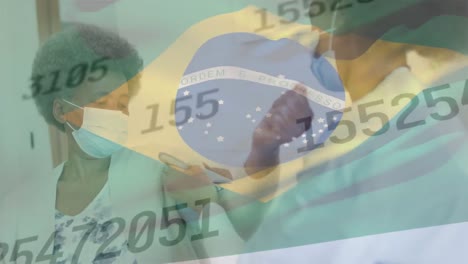 Animation-of-flag-of-brazil-and-data-processing-over-african-american-doctor-and-patient