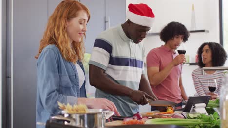 Happy-group-of-diverse-friends-cooking-dinner-in-kitchen-together