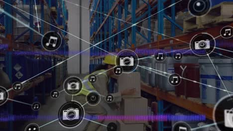 Animation-of-network-of-connections-with-icons-over-african-american-warehouse-worker