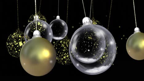 Animation-of-christmas-baubles-dangling-over-snow-falling-on-black-background