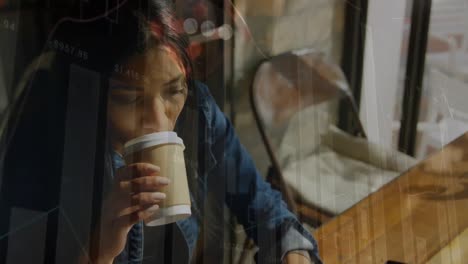 Animation-of-graphs,-falling-dice-over-biracial-woman-drinking-coffee-and-working-on-laptop-at-cafes