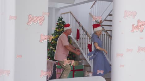 Animation-of-joy-text-over-senior-caucasian-couple-wearing-santa-hats-and-dancing