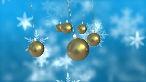 Animation-of-christmas-baubles-dangling-over-snow-falling-on-blue-background