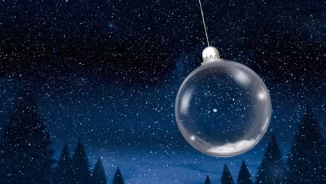 Animation-of-christmas-bauble-dangling-over-snow-falling-in-winter-scenery