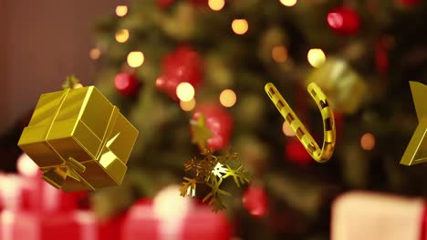 Animation-of-christmas-gold-decorations-falling-over-christmas-tree-in-background