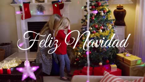 Animation-of-feliz-navidad-text-over-caucasian-mother-and-daughter-at-christmas