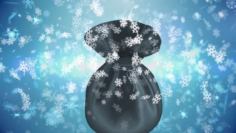 Animation-of-snow-falling-over-bag-on-blue-backrgound