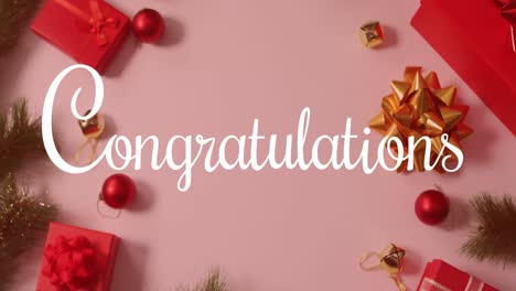 Animation-of-congratulations-text-over-christmas-decorations-on-pink-backrgound