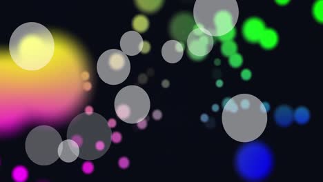 Animation-of-white-and-colorful-spots-of-light-floating-against-black-background