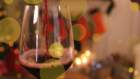 Animation-of-dots-moving-over-glass-of-wine-in-room-with-christmas-decorations