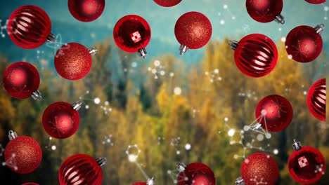 Animation-of-snow-falling-over-christmas-red-baubles-decorations