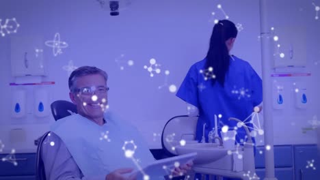 Animation-of-molecules-over-male-patient-in-dentist's-chair