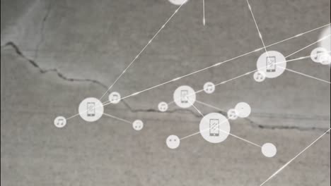 Animation-of-network-of-connections-with-icons-over-crack-in-grey-surface