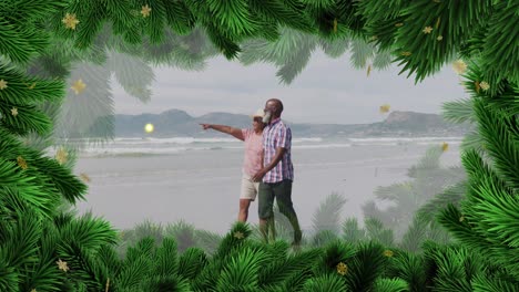 Animation-Von-Weihnachtsdekorationen-über-Einem-älteren-Afroamerikanischen-Paar-Am-Strand