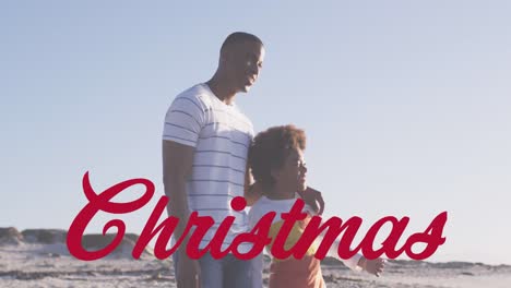 Animation-Von-Weihnachtsgrüßen-über-Afroamerikaner-Mit-Sohn-Am-Strand