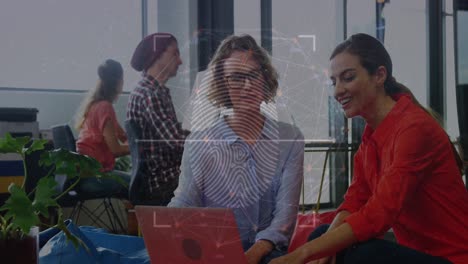 Animation-of-biometric-fingerprint-scanner-over-two-diverse-female-colleagues-discussing-over-laptop