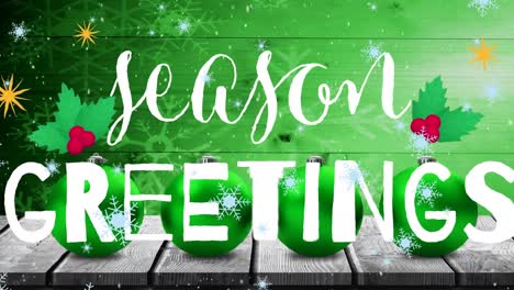 Animation-of-snowflakes-falling-over-seasons-greetings-text-banner-and-baubles-over-wooden-plank