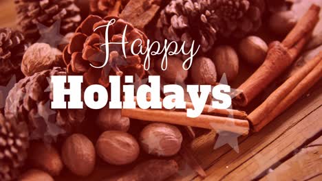 Animation-of-happy-holidays-text-banner-over-pine-cones-and-cinnamon-sticks-on-wooden-surface