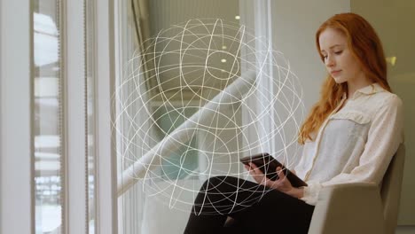 Animation-of-geometric-globe-icon-spinning-over-caucasian-woman-using-digital-tablet-at-office
