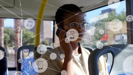 Animation-of-network-of-connections-over-african-american-woman-talking-on-smartphone-in-bus