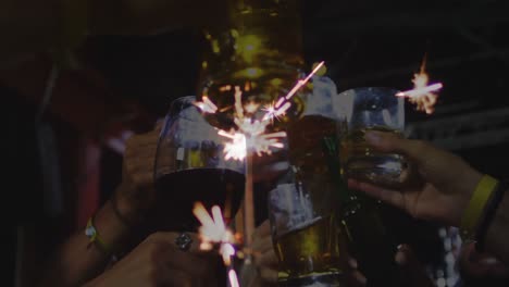 Animation-of-sparkler-over-friends-making-toast-with-champagne-glasses