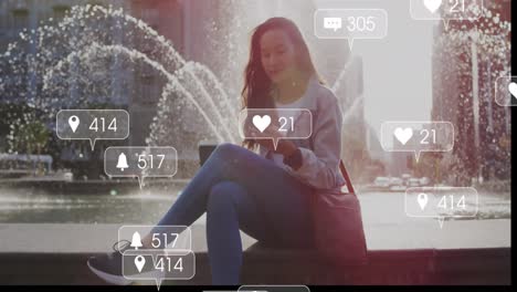 Animation-of-social-media-icons-and-business-data-over-biracial-woman-using-smartphone