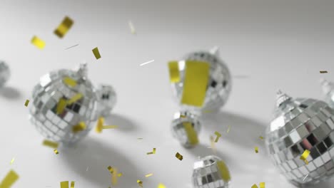 Animation-of-gold-confetti-falling-and-silver-baubles