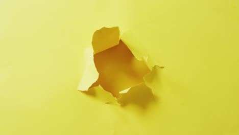Video-of-close-up-of-tron-yellow-paper-on-yellow-background