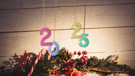 Animation-of-2025-text-and-christmas-decorations-in-background