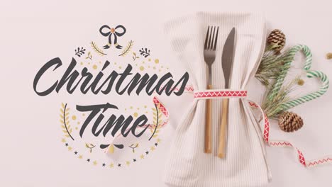 Animation-of-christmas-greetings-text-over-place-setting-and-decorations
