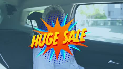 Animation-of-huge-sale-over-african-american-man-sitting-in-car