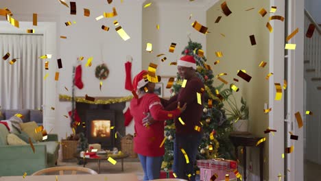 Animation-of-confetti-over-african-american-couple-with-santa-hats-dancing