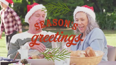 Animation-of-christmas-greetings-text-over-caucasian-family-in-santa-hats-at-christmas-table
