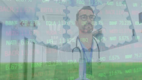 Animation-of-stock-market-data-processing-over-caucasian-male-doctor-walking-in-hospital-corridor