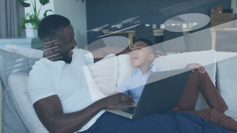 Animation-of-statistical-data-processing-over-african-american-father-and-son-using-laptop-at-home