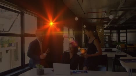Animation-of-light-spots-over-diverse-business-people-working-in-office
