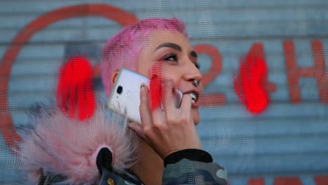 A-pink-haired-woman-is-talking-on-her-mobile-phone-outside-of-a-store,-surrounded-by-a-global-networ