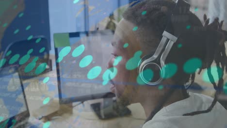 Animation-of-data-processing-over-close-up-of-african-american-man-wearing-headphones-at-office