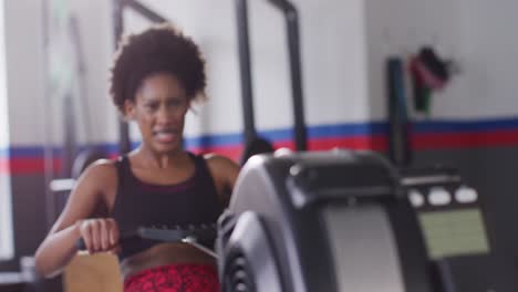 Video-Einer-Entschlossenen-Afroamerikanischen-Frau,-Die-Im-Fitnessstudio-Ein-Rudergerät-Benutzt